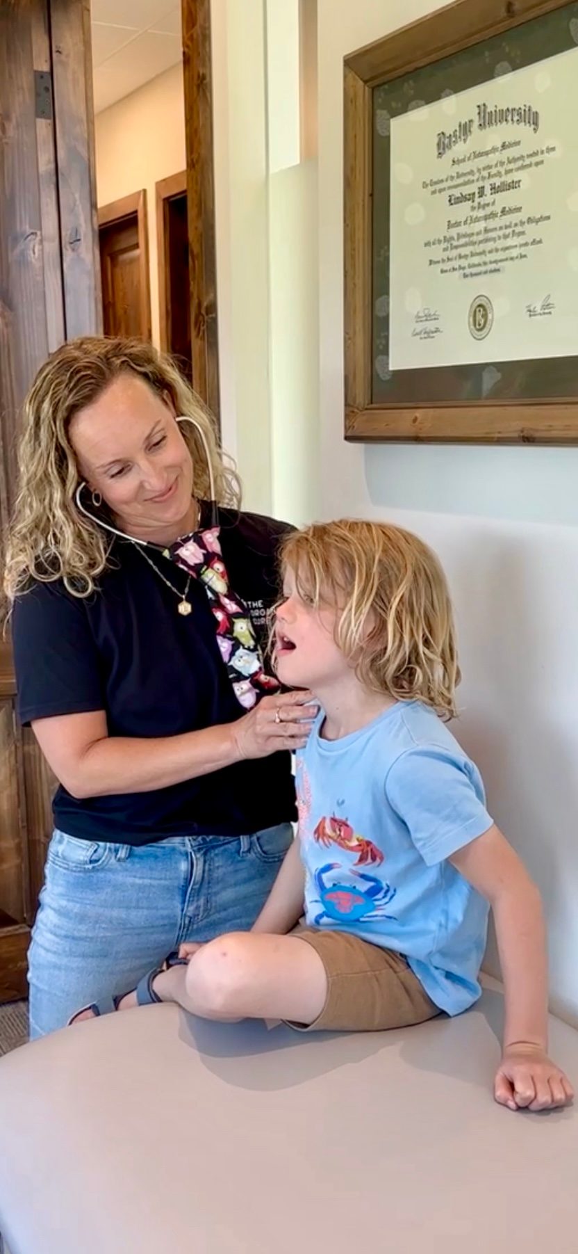Dr. Lindsay with a young child during a clinic visit